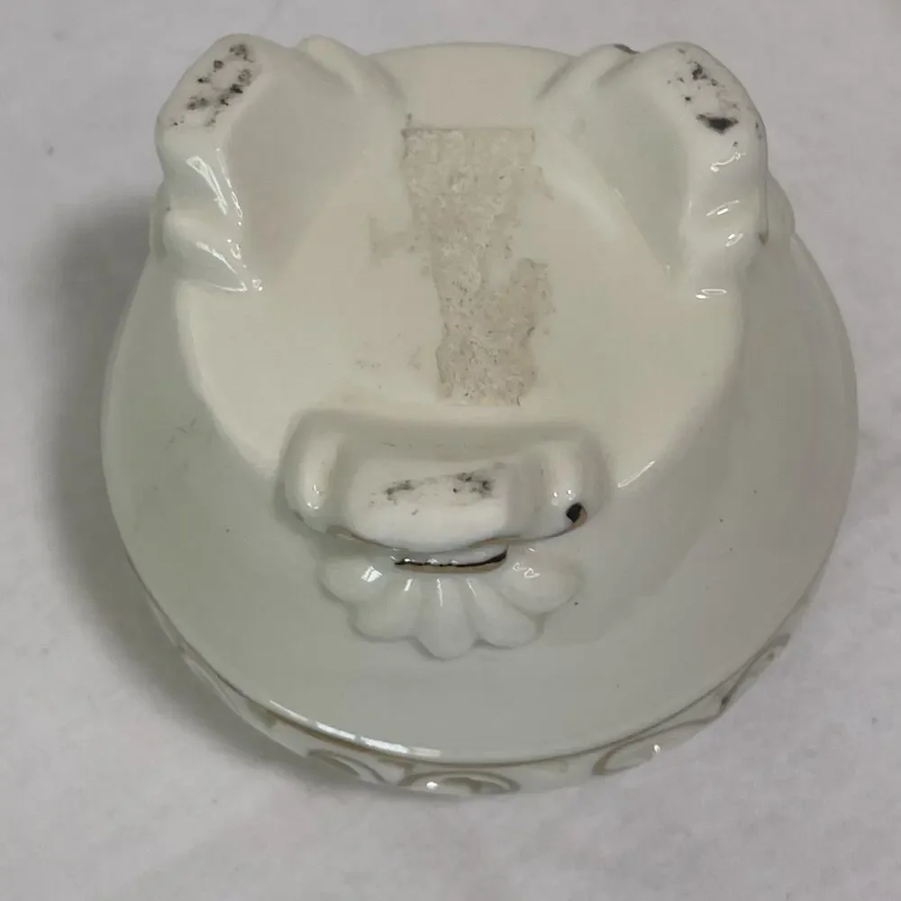 Porcelain Tea Light Holder Cream and Gold Gilding. Three Feet and Cut Outs.